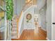 Elegant foyer featuring hardwood floors, a staircase, and stylish decor for a warm welcome at 4460 Wimberly Way, Cumming, GA 30028