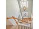 Bright foyer and stairway with hardwood floors, carpeted stairs, and a hanging chandelier at 4460 Wimberly Way, Cumming, GA 30028