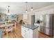 Open-concept kitchen and dining area with stainless steel appliances, wooden floors, and ample space at 4460 Wimberly Way, Cumming, GA 30028