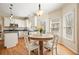 Bright kitchen with white cabinets, stainless steel appliances, and a cozy dining area with backyard views at 4460 Wimberly Way, Cumming, GA 30028