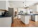 Modern kitchen features white cabinetry, stainless steel appliances, an island, and hardwood floors at 4460 Wimberly Way, Cumming, GA 30028