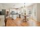 Open kitchen featuring white cabinetry, stainless steel appliances, and a sunny breakfast nook at 4460 Wimberly Way, Cumming, GA 30028