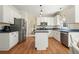 Well-lit kitchen with white cabinets, stainless steel appliances, and hardwood flooring, offering a blend of style and function at 4460 Wimberly Way, Cumming, GA 30028