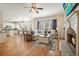 Open concept living room with a fireplace, adjacent kitchen and dining, and comfortable seating at 4460 Wimberly Way, Cumming, GA 30028