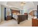 Spacious main bedroom with tray ceilings, dark wood furniture, and natural light at 4460 Wimberly Way, Cumming, GA 30028