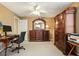 Bright office space with classic wood furniture, neutral carpet, and a ceiling fan at 4460 Wimberly Way, Cumming, GA 30028