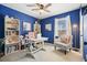 Bright blue office with large window, white bookshelves, and a comfortable chair at 4460 Wimberly Way, Cumming, GA 30028