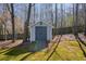 A well-maintained backyard shed with a concrete ramp, providing extra storage space for tools and equipment at 4460 Wimberly Way, Cumming, GA 30028