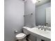 Powder room featuring pedestal sink and toilet in a neutral color palette at 4871 Ship Jack Ln, Decatur, GA 30035
