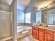 Bathroom showcasing a bathtub with decorative tile, a shower and dual vanity at 4871 Ship Jack Ln, Decatur, GA 30035