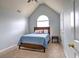 Bedroom featuring vaulted ceilings, an arched window and neutral carpeting at 4871 Ship Jack Ln, Decatur, GA 30035