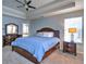 Primary bedroom with a trey ceiling, a ceiling fan, two windows and a large bed at 4871 Ship Jack Ln, Decatur, GA 30035