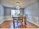 Dining room featuring hardwood floors, light gray walls, a table with chairs, and a pendant light at 4871 Ship Jack Ln, Decatur, GA 30035