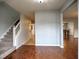 Inviting entryway with hardwood floors, leading to a staircase and a view of the dining area at 4871 Ship Jack Ln, Decatur, GA 30035