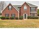 Charming two-story brick home featuring a manicured front lawn and traditional architectural details at 4871 Ship Jack Ln, Decatur, GA 30035