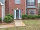 Close-up of a home's entrance, featuring a decorative door, sidelights, and manicured bushes at 4871 Ship Jack Ln, Decatur, GA 30035