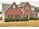 A well-maintained two-story home with brick facade, complemented by lush greenery in the front yard at 4871 Ship Jack Ln, Decatur, GA 30035