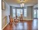 Living room featuring new hardwood floors, light gray walls, lots of light, and a new front door at 4871 Ship Jack Ln, Decatur, GA 30035