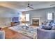 Inviting living room with fireplace, hardwood floors, a ceiling fan, and comfortable seating at 4871 Ship Jack Ln, Decatur, GA 30035