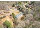 Aerial view showcases a home in a quiet neighborhood among mature trees at 6365 Mountain View Trl, Cumming, GA 30041
