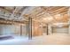Unfinished basement offering potential for customization, with exposed ceiling and concrete walls at 6365 Mountain View Trl, Cumming, GA 30041