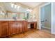 The bathroom boasts and sinks, wood cabinets, and tiled floors in the water closet at 6365 Mountain View Trl, Cumming, GA 30041