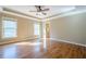Spacious bedroom featuring hardwood floors, a tray ceiling, and plenty of natural light at 6365 Mountain View Trl, Cumming, GA 30041