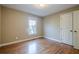 Comfortable bedroom with hardwood floors, a window view, a closet and neutral walls at 6365 Mountain View Trl, Cumming, GA 30041