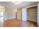 This bedroom features beautiful wood floors and a spacious closet with sliding door at 6365 Mountain View Trl, Cumming, GA 30041