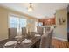 An open-concept dining room featuring hardwood floors and modern finishes adjacent to the kitchen area at 6365 Mountain View Trl, Cumming, GA 30041