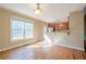 Bright dining area with hardwood floors and large window, flowing into the kitchen at 6365 Mountain View Trl, Cumming, GA 30041