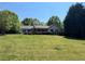 Traditional ranch-style home featuring a cozy front porch and a lush green lawn at 6365 Mountain View Trl, Cumming, GA 30041