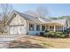 Attractive one-story home with a spacious two-car garage, long driveway and front porch at 6365 Mountain View Trl, Cumming, GA 30041