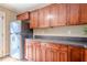 Well-appointed kitchen features stainless steel refrigerator and wood cabinets at 6365 Mountain View Trl, Cumming, GA 30041