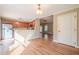 Open-concept kitchen with wood cabinets and hardwood floors connecting to the living area at 6365 Mountain View Trl, Cumming, GA 30041