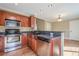 Efficient kitchen layout with stainless steel appliances and wood cabinetry at 6365 Mountain View Trl, Cumming, GA 30041