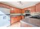Modern kitchen with stainless steel appliances and wood cabinets at 6365 Mountain View Trl, Cumming, GA 30041
