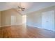 Spacious main bedroom featuring hardwood floors, a ceiling fan, and ample closet space in neutral decor at 6365 Mountain View Trl, Cumming, GA 30041