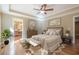 Comfortable main bedroom showcases hardwood floors, neutral tones, and a view to the ensuite at 6365 Mountain View Trl, Cumming, GA 30041