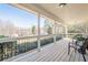 Covered porch with railing providing an outdoor sitting area at 6365 Mountain View Trl, Cumming, GA 30041
