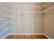 A walk-in closet features extensive shelving and hardwood floors at 6365 Mountain View Trl, Cumming, GA 30041