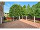 Spacious deck offers outdoor living space with views of lush, mature trees in the backyard at 8056 Revere Dr, Mcdonough, GA 30252
