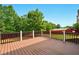 Spacious deck offers outdoor living space with views of lush, mature trees in the backyard at 8056 Revere Dr, Mcdonough, GA 30252
