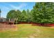 Large backyard with lush greenery, featuring a patio and deck perfect for outdoor activities at 8056 Revere Dr, Mcdonough, GA 30252