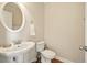 Powder room offers a pedestal sink, a toilet and a decorative oval mirror with matching fixtures at 8056 Revere Dr, Mcdonough, GA 30252