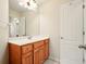 Bathroom featuring wood cabinets, white counter and mirror with decorative lighting at 8056 Revere Dr, Mcdonough, GA 30252