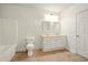 Bright bathroom features a double vanity, bathtub with white tile surround, and neutral tile flooring at 8056 Revere Dr, Mcdonough, GA 30252