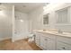Bright bathroom features a double vanity, bathtub with white tile surround, and neutral tile flooring at 8056 Revere Dr, Mcdonough, GA 30252