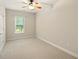 Bright and airy bedroom with neutral walls, carpet, window, ceiling fan, and ample closet space at 8056 Revere Dr, Mcdonough, GA 30252