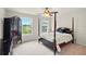 Bedroom with a four-poster bed, dresser, and large windows with a view at 8056 Revere Dr, Mcdonough, GA 30252